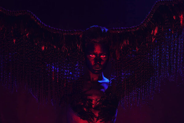 Girl in black paint with horns