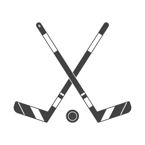 Two crossed ice hockey sticks and puck — Stock Vector © Jirkapravda