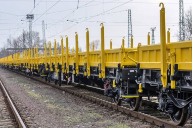 Burgas, Bulgaria - January 27, 2017 - Freight cargo train - 4-axled flat wagon Type:Res Model:072-2 - Transvagon AD clipart