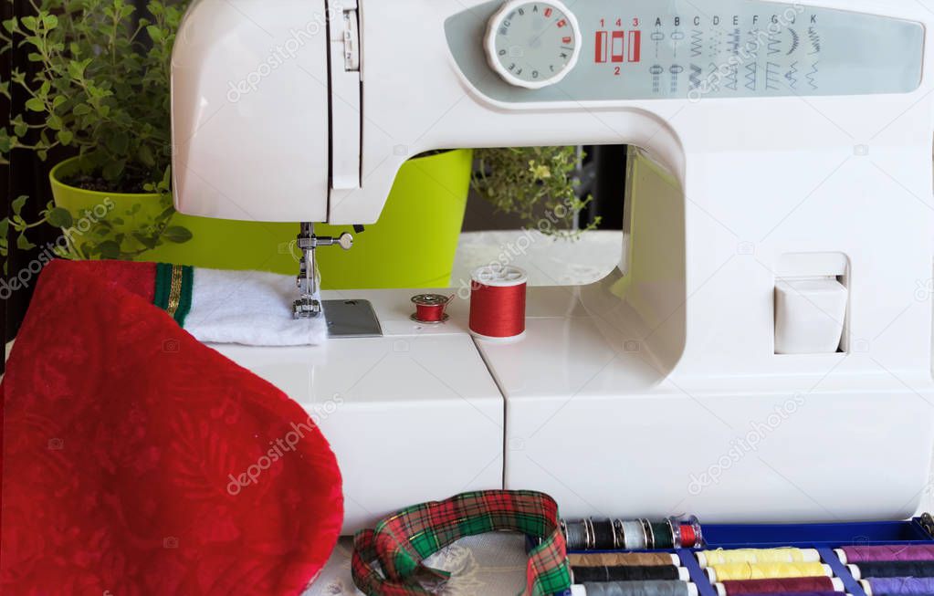 Preparing for Christmas.  Sewing machine sewing a Christmas stocking. Christmas sewing