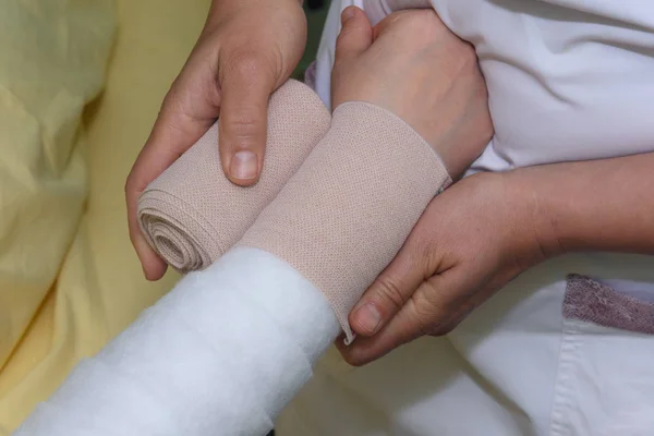 Lymphedema management: Wrapping Lymphedema Hand and Arm using multilayer bandages to control Lymphedema. Part of complete decongestive therapy (cdt) and manual lymphatic drainage (MLD) — Stock Photo, Image