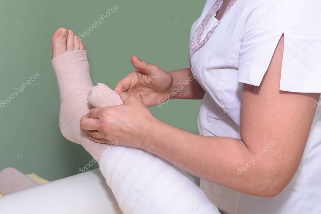 Lymphedema management: Wrapping leg using multilayer bandages to control Lymphedema. Part of complete decongestive therapy (cdt) and manual lymphatic drainage (MLD)