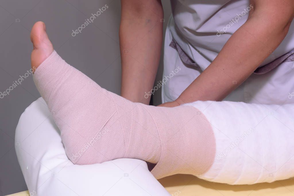 Lymphedema management: Wrapping leg using multilayer bandages to control Lymphedema. Part of complete decongestive therapy (cdt) and manual lymphatic drainage (MLD)