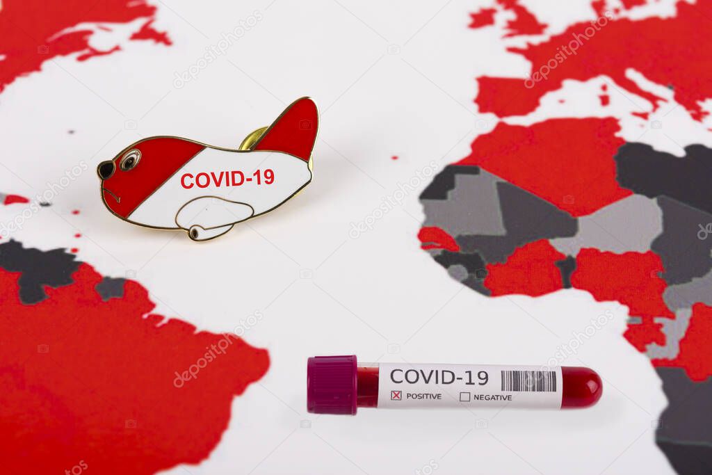 Coronavirus and travel concept. Coronavirus outbreak, epidemic in Wuhan, China. Travel restrictions and quarantine. Blood sample in a tube on a world map showing countries with COVID-19 cases