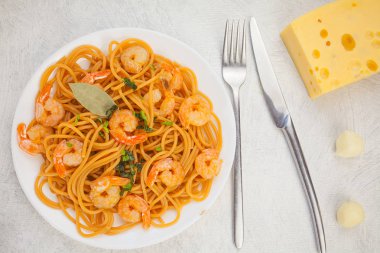 delicious delicious spaghetti with shrimps on wooden background clipart