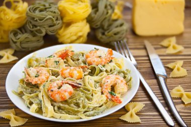 delicious fettuccine pasta with prawns on white plate clipart