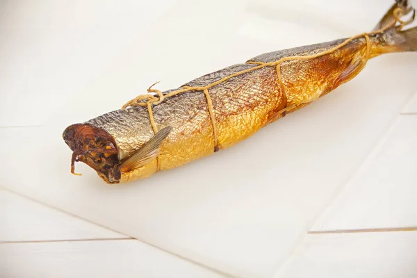 Hot smoked salmon fish on kitchen board on table — Stock Photo, Image