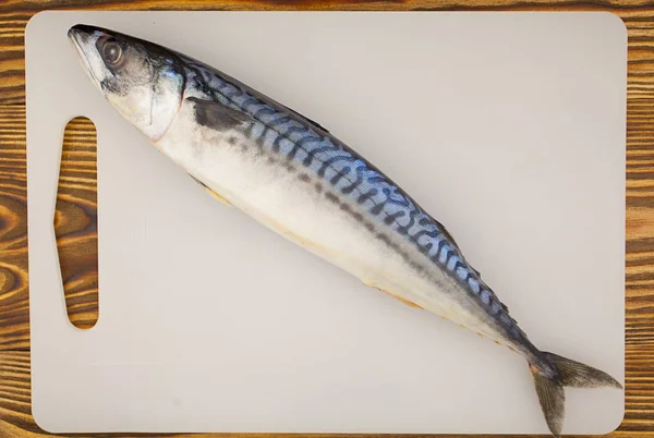 Appetizing salted mackerel on cutting board on wooden table — Stock Photo, Image