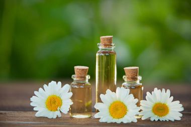 Essence of flowers on table in beautiful glass jar clipart