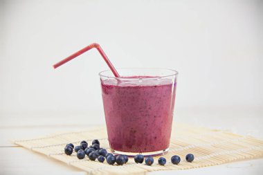 Yaban mersini milkshake beyaz masada güzel cam