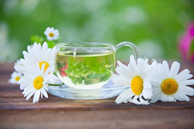 Crystal cup with green tea on table clipart