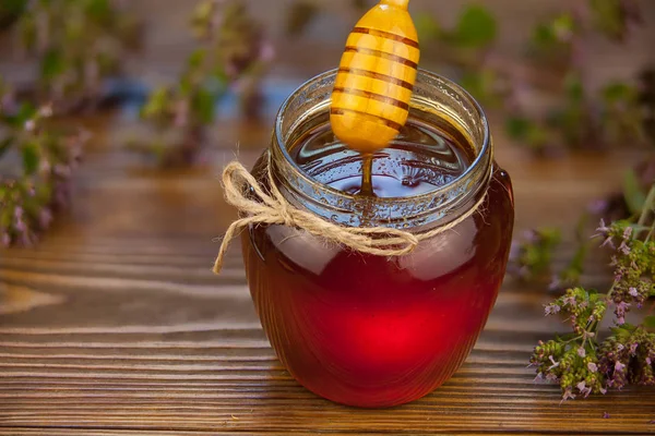 Delicious delicious honey in  jar on table — Stock Photo, Image