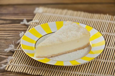 delicious cheesecake with coconut on  plate clipart