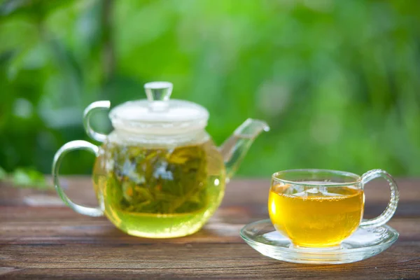 Crystal cup with green tea on table — Stock Photo, Image