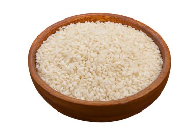 Raw rice groats for risotto on a plate clipart