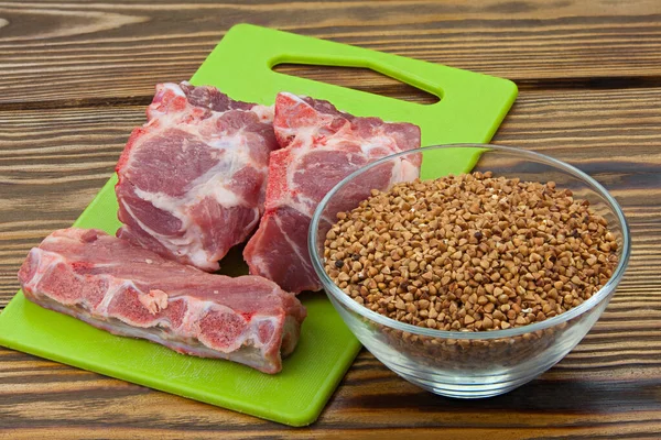 raw red pig meat on a wooden background