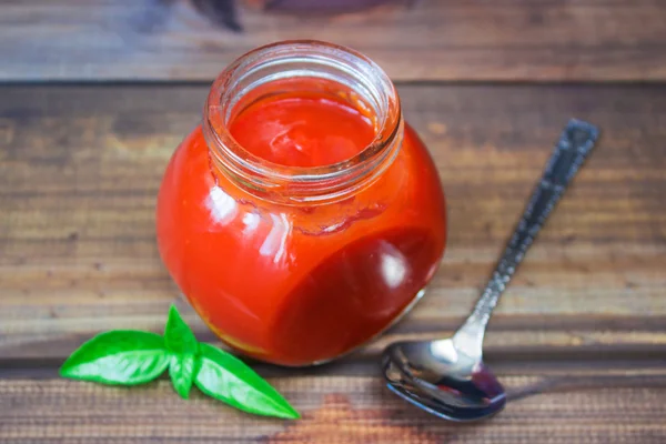 Homemade ketchup in a glass jar. tomato sauce — Stock Photo, Image