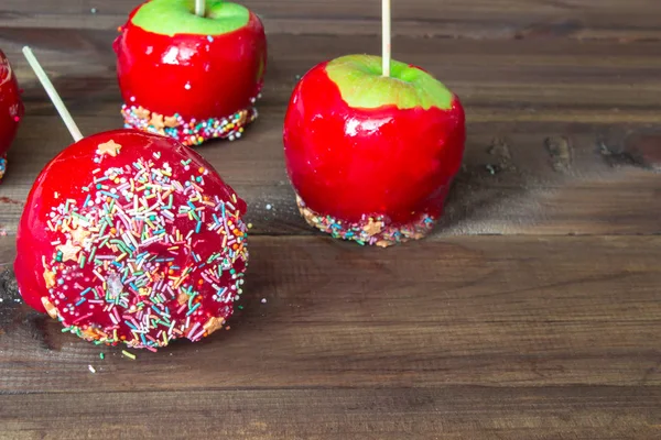 candy apples on wooden table