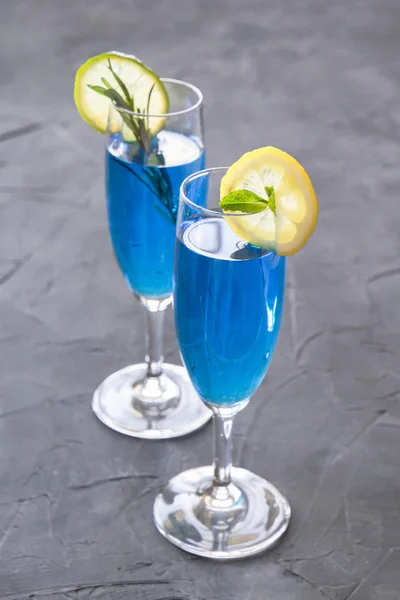Blue curacao cocktail with rosemary, lime and lemon — Stock Photo, Image