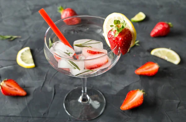 Cocktail made from Strawberries and rosemary ice cubes into the glass — Stock Photo, Image