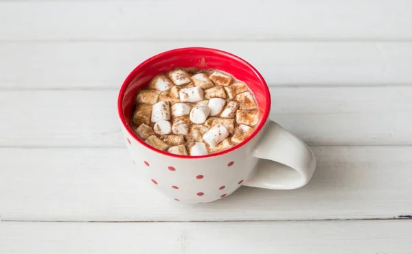 Heiße Schokolade in roter Tasse auf weißem Holzhintergrund — Stockfoto