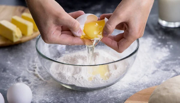 woman separating the yolk from the egg white