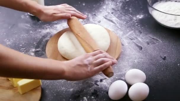 Making dough by female hands on wooden table background — Stock Video