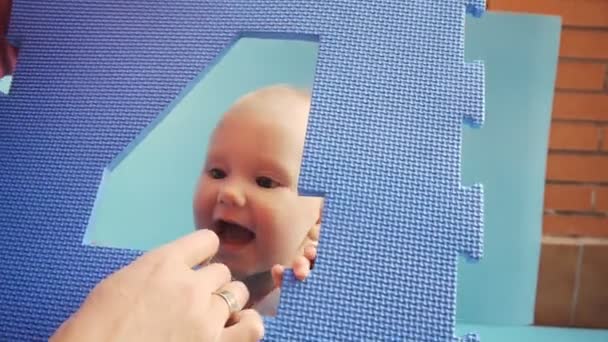 Baby und Mutter spielen mit EVA-Puzzlematte — Stockvideo