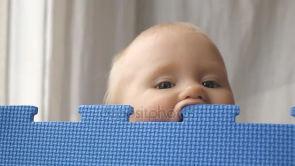 Baby plays with eva puzzle mat — Stock Video