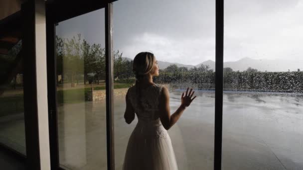 Lovely couple near window with raindrops. — Stock Video