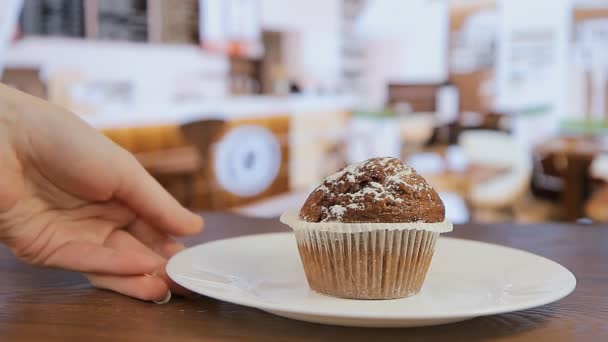 Delicioso muffin en un plato blanco en un café — Vídeo de stock