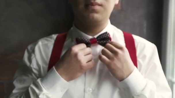 Joven asiático hombre usando un moño corbata — Vídeo de stock