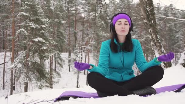 Fille souriante pratiquant le yoga en hiver — Video