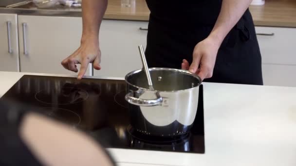 Mixing in a saucepan with a whisk — Stock Video