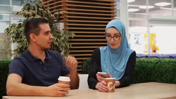 Muslim girl and young man posing looking at camera, embrace — Stock Video