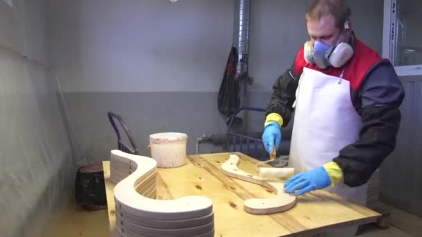 Industrial carpenter worker varnishing on wood dolly shot — Stock Video