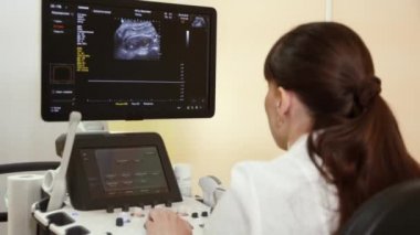 Doktor önünde monitör ultrason muayenesi gebelik kliniğinde