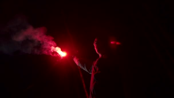 A man holds in his hand a signal fire in the forest slow mo — Stock Video