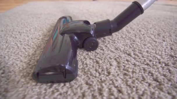 Close up of a vacuum cleaner vacuuming the carpet — Stock Video