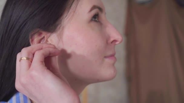 Portrait positive young woman uses ear cleaning hygienic cotton swabs — Stock Video