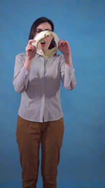 a young pretty woman with glasses and a wallet in her hands is in shock, losing money and saving money