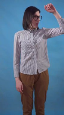 a young woman in a shirt can smell sweat discontented