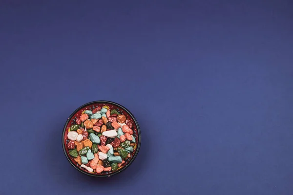 Candy bowl with sweets in the form of colored stones. colorful candies