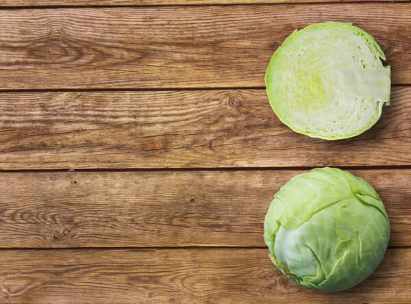 Fresh green garden cabbage on rustic wooden background