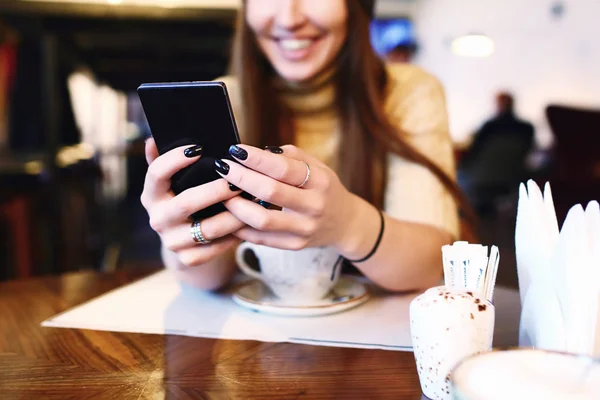 Close up of womens hands holding cell telephone with blank copy space scree for your advertising text message or promotional content, hipster girl watching video on mobile phone during coffee break — Stock Photo, Image