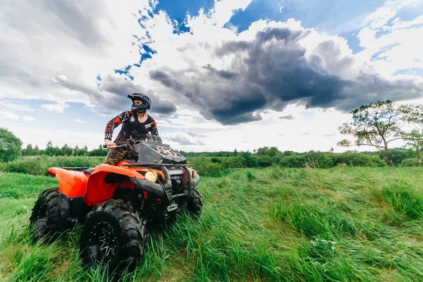 VITEBSK, BELARUS - 11 DE JUNIO DE 2017: Foto del hombre en el ATV Quad Bike corriendo en el campo —  Fotos de Stock