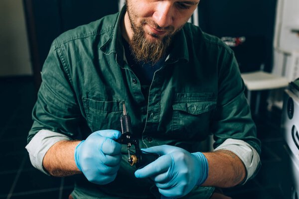 tattoo master artist prepares tools for tattooing