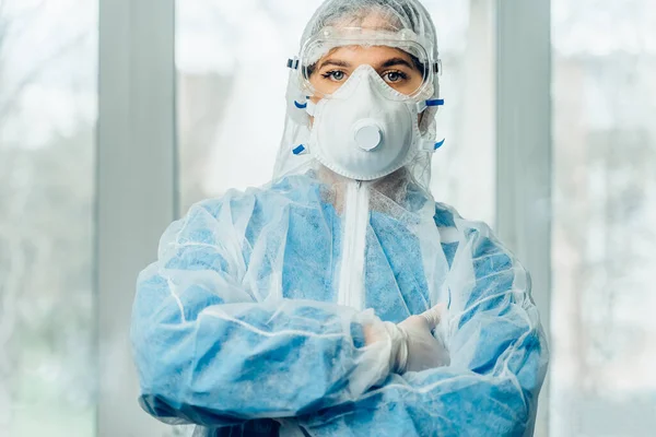 Portrait of woman doctor weaing protective suit during coronavirus pandemic, . Hazard suit, respiratory mask, gloves and glasses clinic or hospital. Protection from coronavirus, covid-19 epidemic