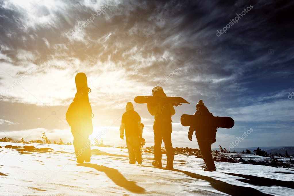 Group snowboarders snowboarding skiing concept