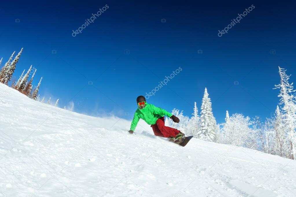 Snowboarder rides on slope snowboarding